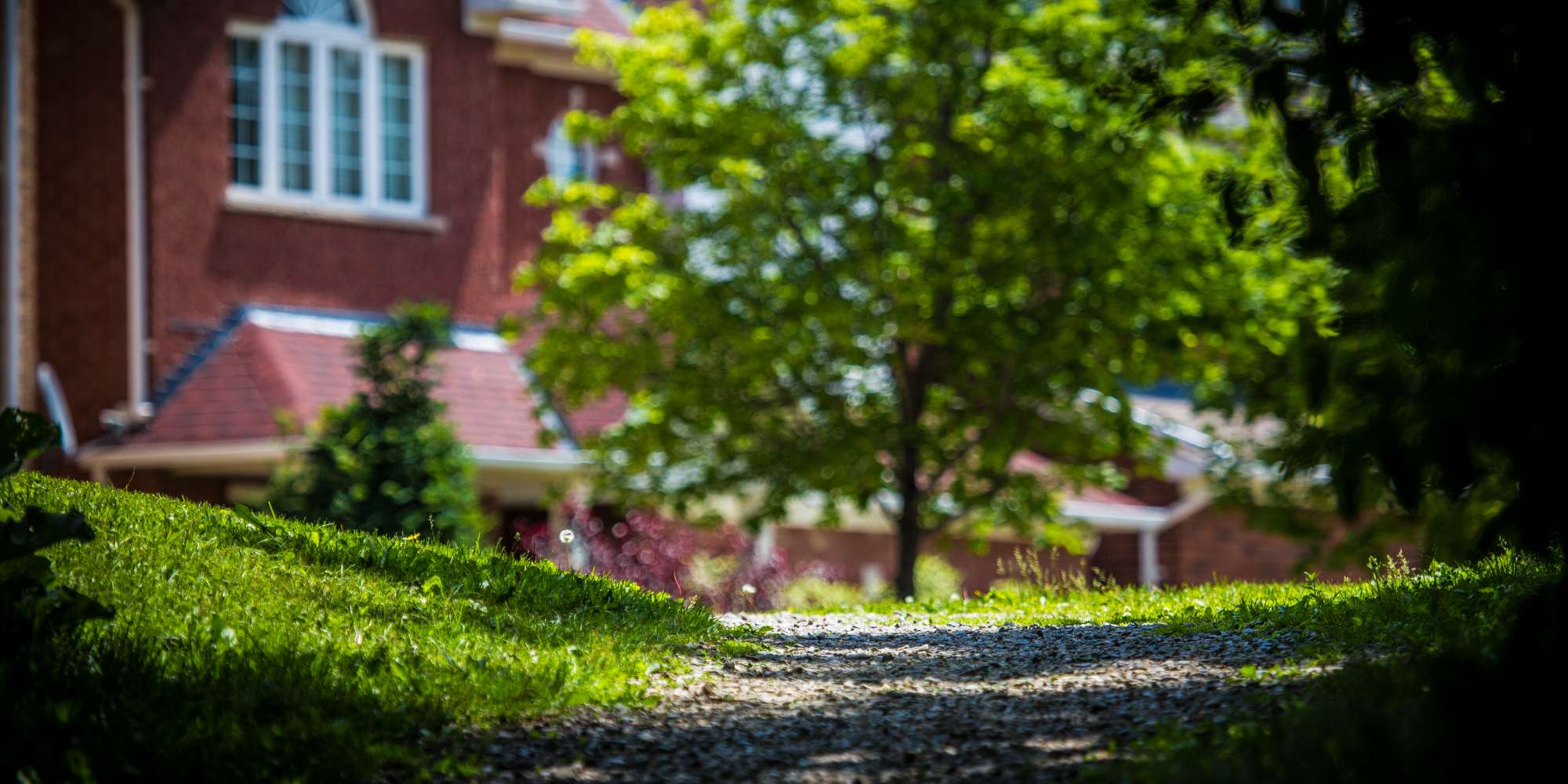 Historic red brick heritage home surrounded by mature trees in Meadowvale Village Mississauga
