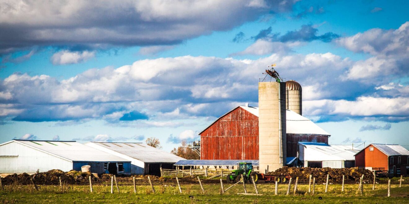 Farm with red barn and silo surrounded by fall colours in the Cobban community, Milton, Ontario