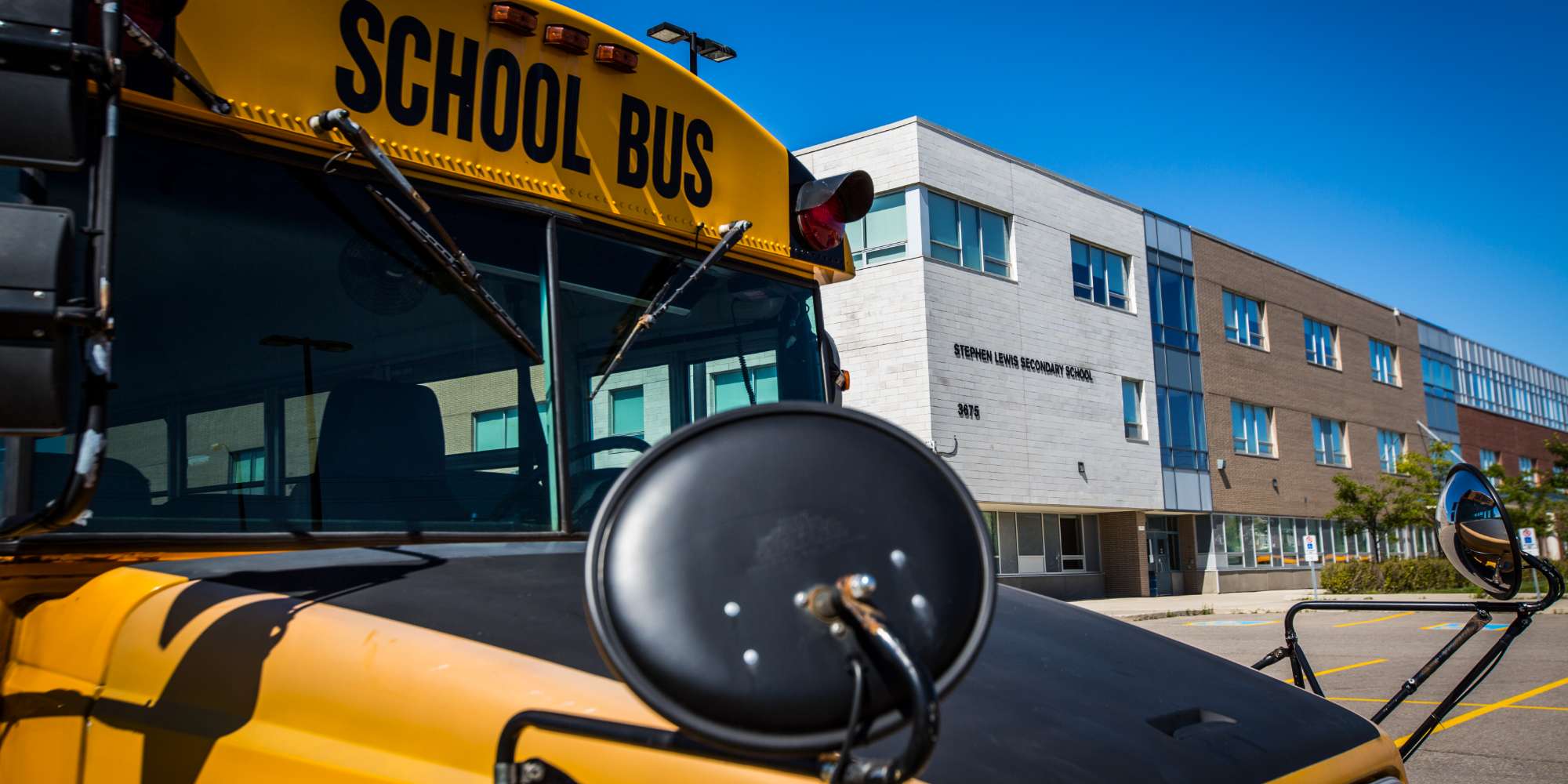 Yellow school bus on route in Churchill Meadows neighbourhood Mississauga